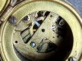 a close up of an old clock with a key in it