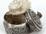 an antique silver box with a lid on a white background