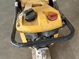 a small yellow machine that is sitting on the ground