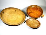 three wooden bowls and a bowl on the table