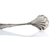 a spoon that is sitting on top of a white surface