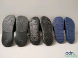four pairs of black and blue shoes lined up on a white surface