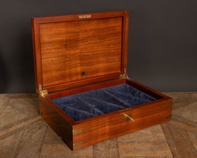 an old wooden box with velvet linings on a wooden floor