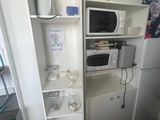 a microwave and a microwave oven in a small room