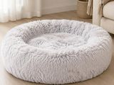 a close up of a dog bed on a wooden floor in a living room