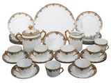 a lot of plates and cups and saucers on the table