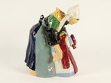 a figurine of a woman holding a book