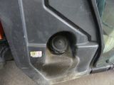a close up of a car door with a small hole in it