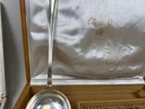 a silver spoon and a silver spoon in a box