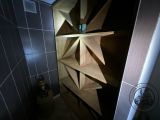a wooden book shelf with a star design on it