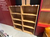 bookshelves in a room with a red wall and a yellow chair