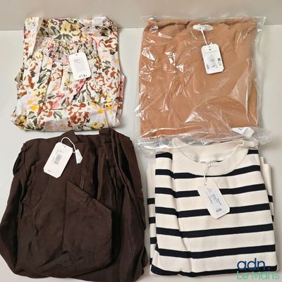 four pieces of clothing sitting on top of a table next to each other
