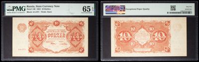 two old red and white bank notes on a black background