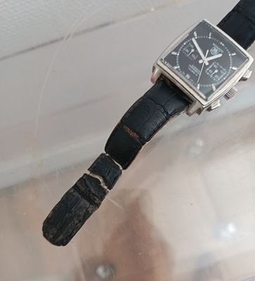 a watch that is sitting on top of a glass table
