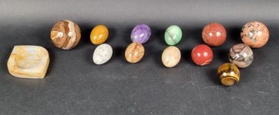 a group of seven different colored stones sitting on top of a table