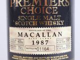 a close up of a bottle of whisky on a white surface