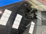 a reflection of a building in the rear window of a car