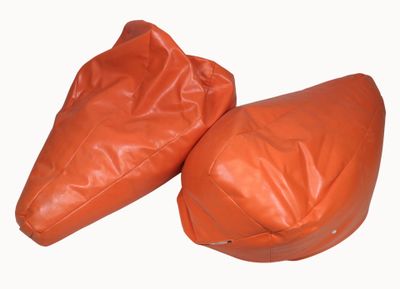 pair of orange leather bean bags on white background