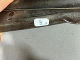 a person holding a gun with a tag on it