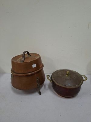 several pots and pans are lined up on a table