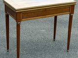 a small wooden table with a marble top on it