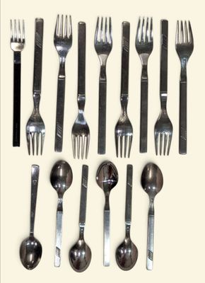 a lot of forks and spoons that are on the table