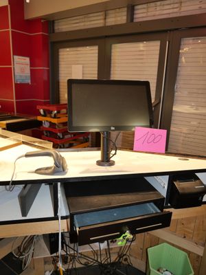 a computer desk with a monitor and a keyboard on it