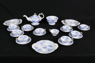 a lot of blue and white china on a black table