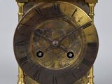 an antique brass clock with a lion on top of it