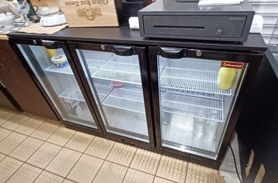 a counter with a refrigerator and a counter top with a box on it