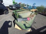 a green machine that is sitting in the parking lot