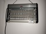a metal heater hanging on the wall next to a white wall