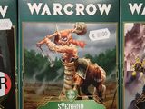 several warcraw cards are on display in a store