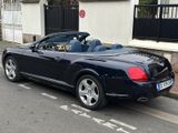 a black convertible car parked on the side of the road