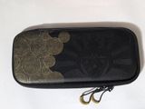 a black case with a gold design on it