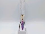 a white box with a purple watch inside of it on a white surface
