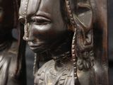 pair of african carved wood statues of a woman and a man