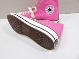 pink converse shoes with white laces on a white surface