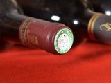 two bottles of wine sitting next to each other on a table