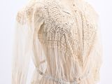 an image of a mannequin wearing a white blouse with sheer sleeves
