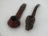two pipe holders sitting on a table with one of them turned upside down