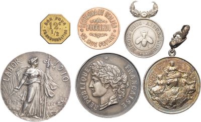 several different types of coins are shown on a white surface