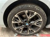 the wheel of a bmw car with a flat tire on the ground