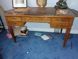 a desk with a clock on top of it in a room