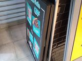 a refrigerator that has a sign on the side of it