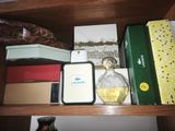 a wooden shelf with a bottle of perfume and other items on it
