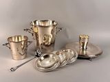 a silver plate with silver cups and spoons on it