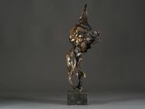 bronze statue of a woman holding a bird on a marble base
