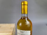 a bottle of wine sitting on a table next to a box