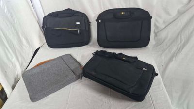 four pieces of luggage sitting on top of a bed next to each other